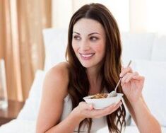 The girl eats porridge buckwheat